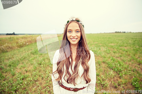 Image of smiling young hippie woman on cereal field