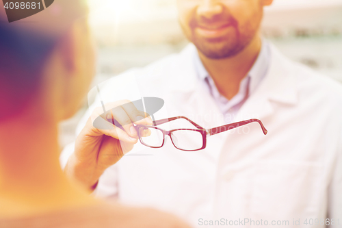 Image of close up of optician with glasses at optics store