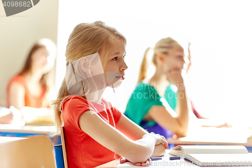 Image of group of students with notebooks at school lesson