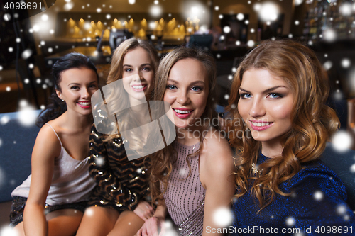 Image of happy smiling women taking selfie at night club