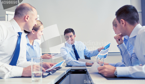 Image of group of smiling businesspeople meeting in office