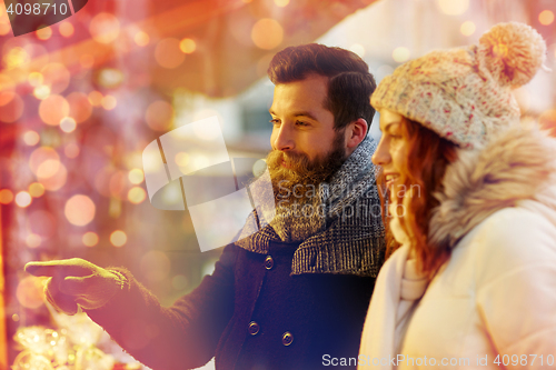 Image of happy couple walking outdoors