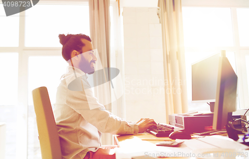 Image of happy creative male office worker with computer