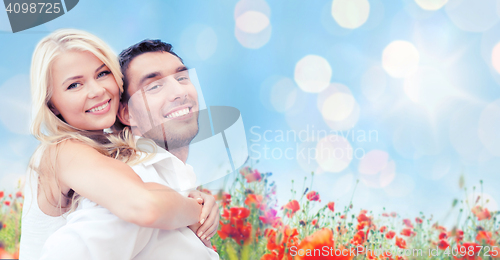 Image of happy couple having fun over poppy flowers field