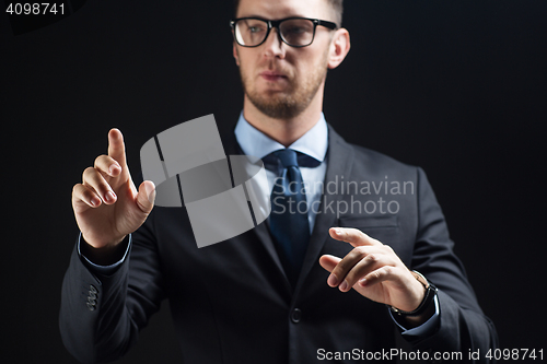 Image of close up of businessman touching virtual screen