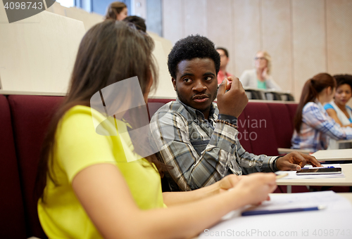 Image of group of students with notebooks at lecture hall