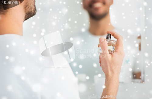 Image of close up of man perfuming with perfume at bathroom