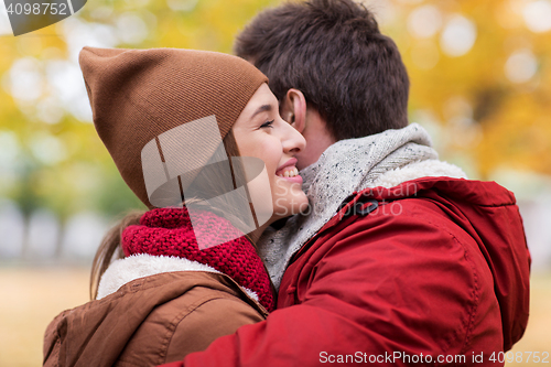 Image of happy young couple hugging in autumn park