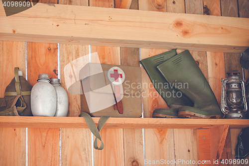 Image of Wooden shelfe with retro surival kit