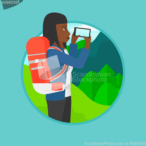 Image of Tourist with backpack taking photo.