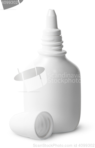 Image of White nasal spray cap beside