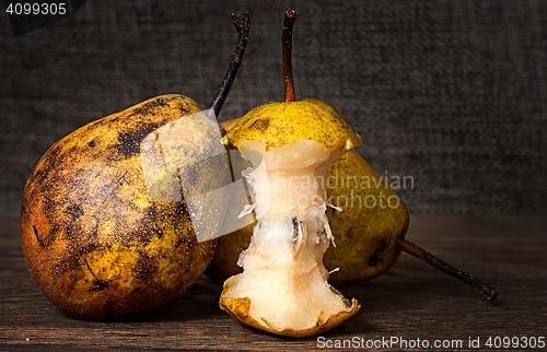 Image of Two pears and stub standing on wooden table
