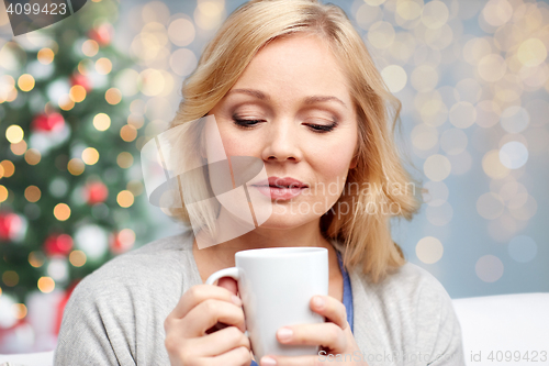 Image of woman with cup of tea or coffee at christmas