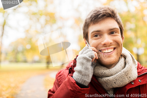 Image of man with smartphone calling on city street