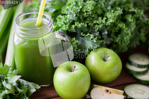 Image of close up of jug with green juice and vegetables