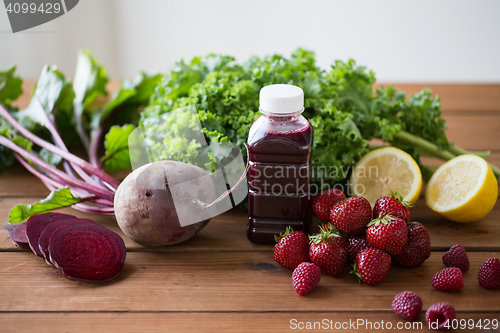 Image of bottle with beetroot juice, fruits and vegetables