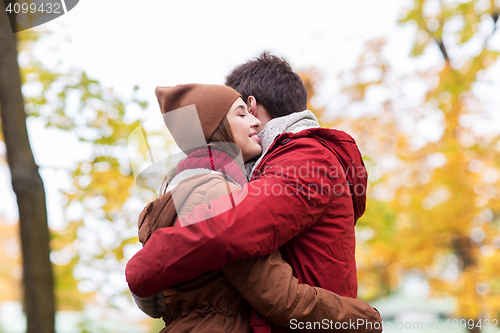 Image of happy young couple hugging in autumn park