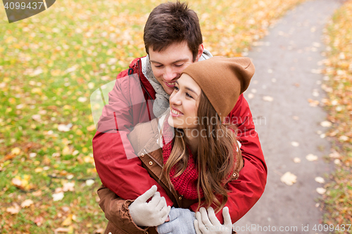 Image of happy young couple hugging in autumn park