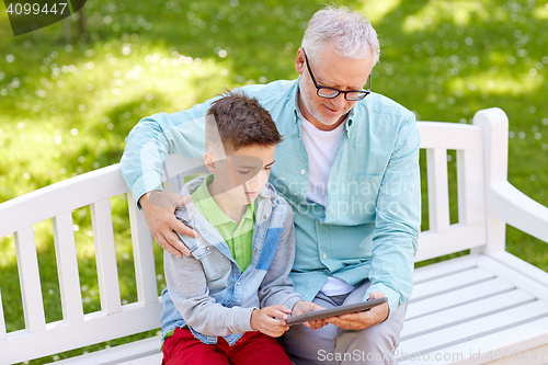 Image of grandfather and boy with tablet pc at summer park