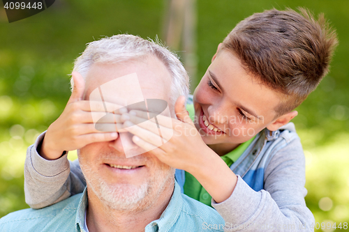 Image of grandfather and grandson playing at summer park