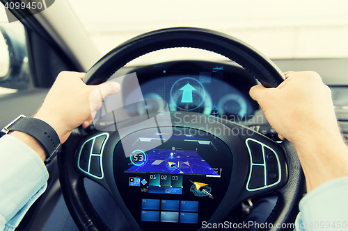 Image of close up of man driving car with gps navigator