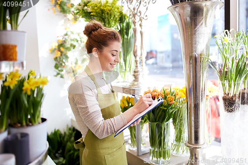 Image of florist woman with clipboard at flower shop