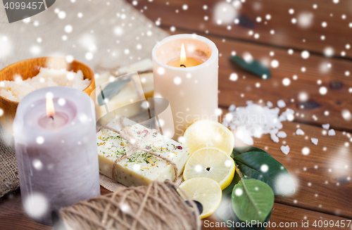 Image of natural soap and candles on wood