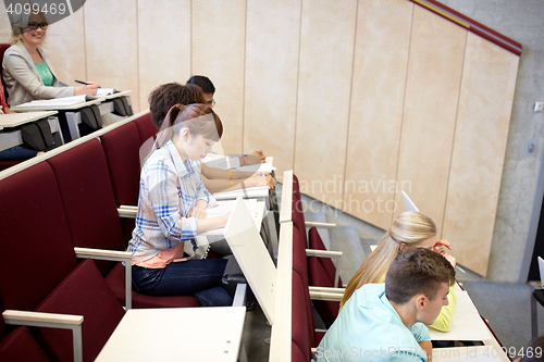 Image of group of students with notebooks at lecture hall