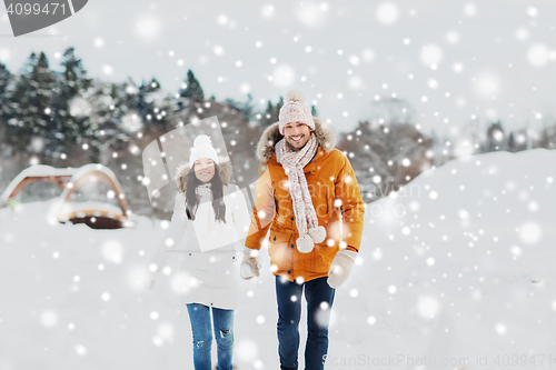 Image of happy couple walking over winter background