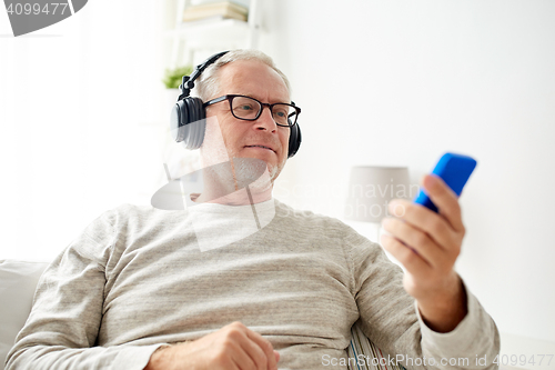 Image of happy senior man with smartphone and headphones