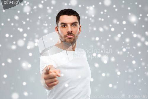 Image of angry man pointing finger to you over snow