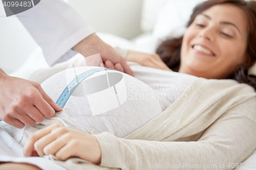 Image of close up of doctor and pregnant woman at hospital