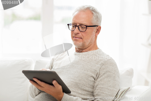 Image of senior man with tablet pc at home