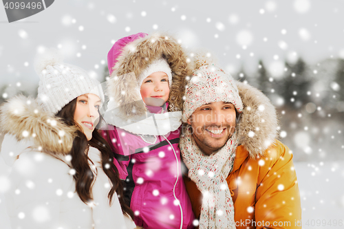 Image of happy family with child in winter clothes outdoors