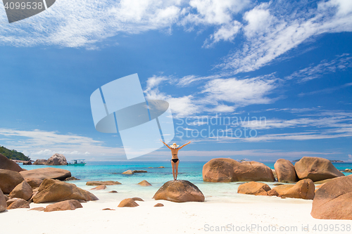 Image of Woman enjoying Anse Lazio picture perfect beach on Praslin Island, Seychelles.