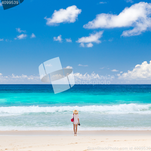 Image of Woman enjoying picture perfect beach on Mahe Island, Seychelles.