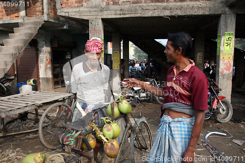 Image of Selling a coconut on  market in Kumrokhali, West Bengal, India