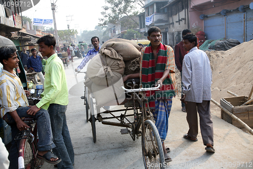 Image of Man drives his goods to market in Kumrokhali, West Bengal, India 