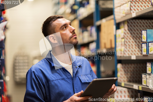 Image of auto mechanic or smith with tablet pc at workshop