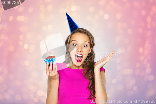 Image of happy woman or teen girl with birthday cupcake