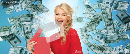 Image of happy woman in red with gifts over money rain