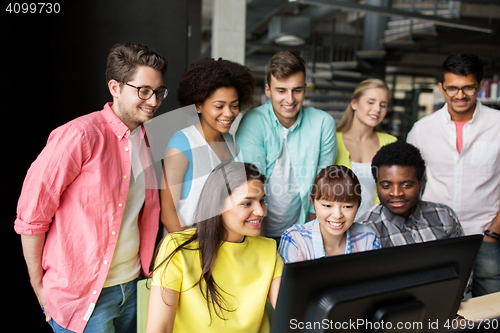Image of international students with computers at library