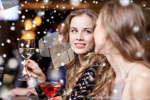 Image of happy women with drinks at night club