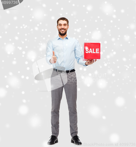 Image of smiling man with red shopping bag