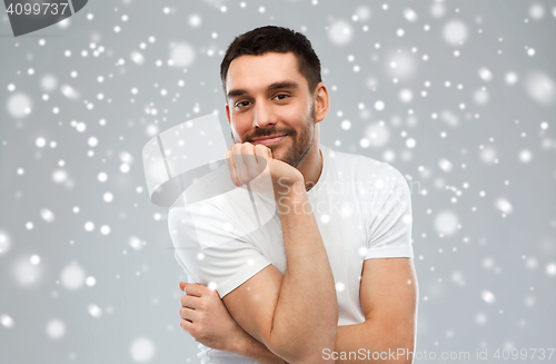 Image of smiling man over snow background