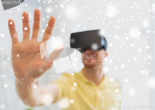 Image of young man in virtual reality headset or 3d glasses