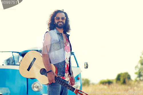 Image of hippie man with guitar over minivan car outdoor