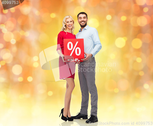 Image of happy couple with red sale sign