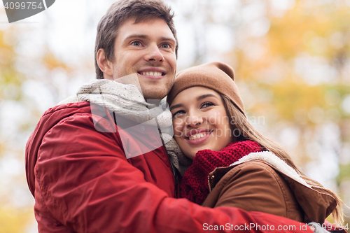 Image of happy young couple hugging in autumn park