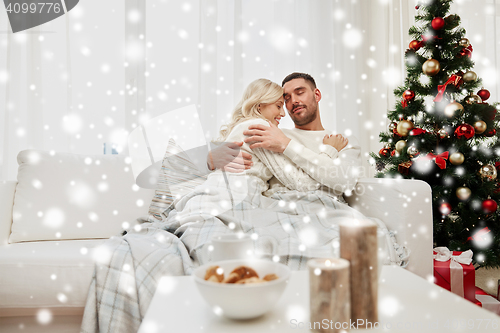 Image of happy couple at home with christmas tree